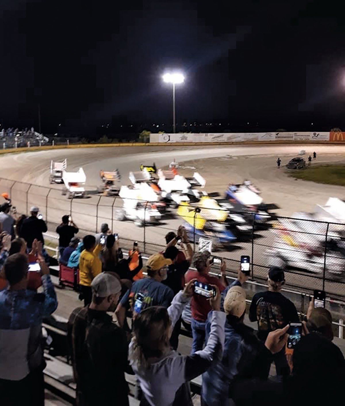 Race fans cheer for their favorite drivers from the stands at the Hendry County Motorsports Park.